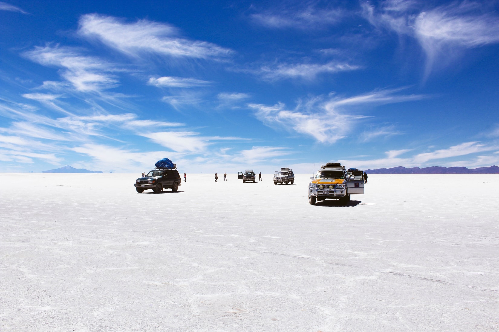 salar de uyuni cars bolivia unsplash Travel Just 4U